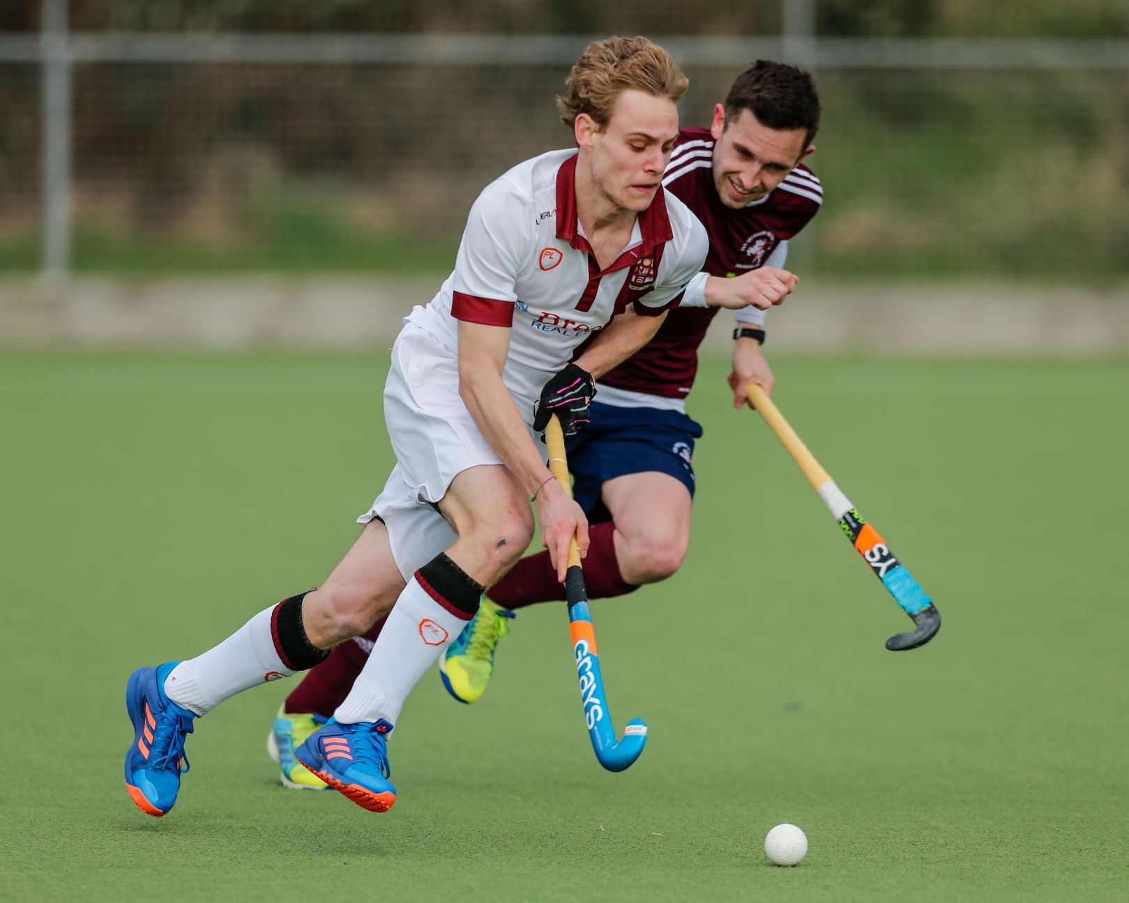 player about to be tackled during a hockey game